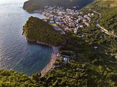 Aerial view of Petrovac and Lucice beach, one of the most beautiful sandy beaches. Umbrellas and bathers at sunset. montenegroの写真素材