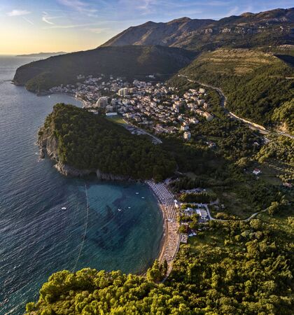 Aerial view of Petrovac and Lucice beach, one of the most beautiful sandy beaches. Umbrellas and bathers at sunset. montenegroの写真素材
