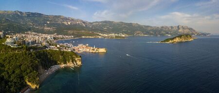 Aerial view of Mogren beach (two sandy beaches) and the old city (stari grad) of Budva, and Sveti Nikola island. Montenegro. Jagged coast on the Adriatic Seaの写真素材