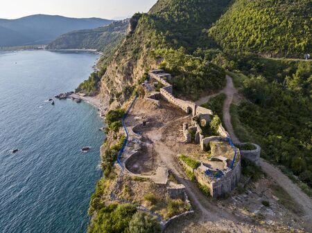 Aerial view of Mogren Fortress, Tvrdava Mogren, it is located on a promontory Mogren between the beaches Mogren and Jaz just a kilometer from the town of Budva. Montenegro. Jagged coastの写真素材