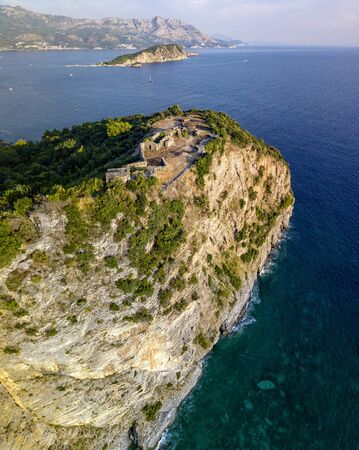 Aerial view of Mogren Fortress, Tvrdava Mogren, it is located on a promontory Mogren between the beaches Mogren and Jaz just a kilometer from the town of Budva. Montenegro. Jagged coastの写真素材