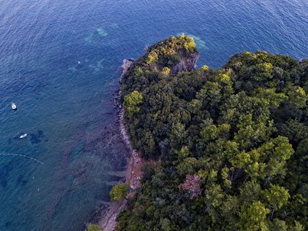 Aerial view of Mogren promontory between the Mogren beaches. Budva. Montenegro. Jagged coasts with sheer cliffs overlooking the transparent sea. Wild nature and Mediterranean maquisの写真素材