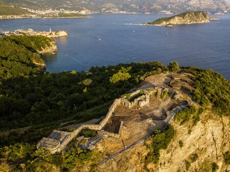 Aerial view of Mogren Fortress, Tvrdava Mogren, it is located on a promontory Mogren between the beaches Mogren and Jaz just a kilometer from the town of Budva. Montenegro. Jagged coastの写真素材