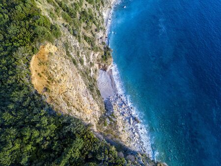 Aerial view of Sveti Nikola, Budva island, Montenegro. Jagged coasts with sheer cliffs overlooking the transparent sea. Wild nature and Mediterranean maquisの写真素材