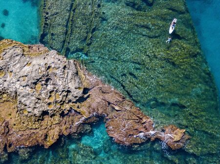 Aerial view of a snorkeling board. Bathers at sea. Tropea, Calabria, Italy. Diving relaxation and summer vacations. Italian coasts, beaches and rocksの写真素材