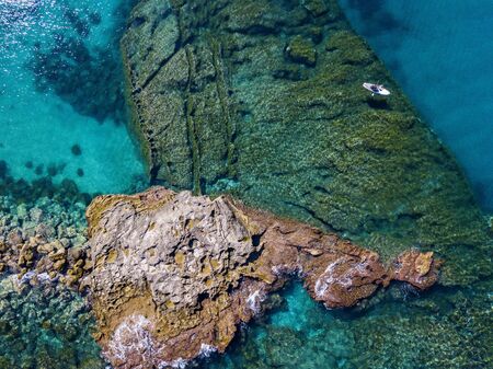 Aerial view of a snorkeling board. Bathers at sea. Tropea, Calabria, Italy. Diving relaxation and summer vacations. Italian coasts, beaches and rocksの写真素材