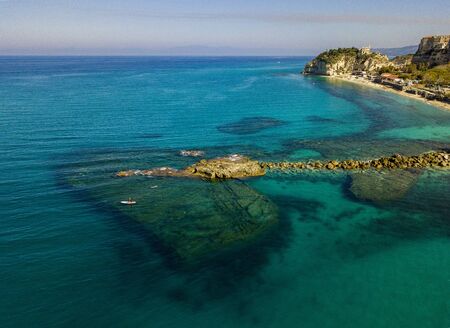 Aerial view of a snorkeling board. Bathers at sea. Tropea, Calabria, Italy. Diving relaxation and summer vacations. Italian coasts, beaches and rocksの写真素材