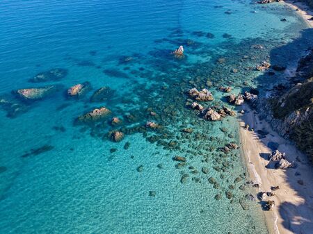 Aerial view of Tropea beach, crystal clear water and rocks that appear on the beach. Calabria, Italy. Swimmers, bathers floating on the water. Coastline of Calabriaの写真素材