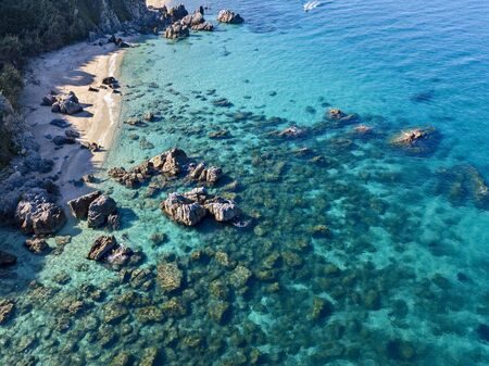 Aerial view of Tropea beach, crystal clear water and rocks that appear on the beach. Calabria, Italy. Swimmers, bathers floating on the water. Coastline of Calabriaの写真素材