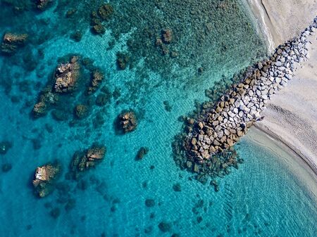 Aerial view of Tropea beach, crystal clear water and rocks that appear on the beach. Calabria, Italy. Swimmers, bathers floating on the water. Coastline of Calabriaの写真素材