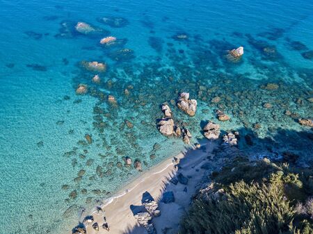 Aerial view of Tropea beach, crystal clear water and rocks that appear on the beach. Calabria, Italy. Swimmers, bathers floating on the water. Coastline of Calabriaの写真素材