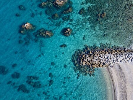 Aerial view of Tropea beach, crystal clear water and rocks that appear on the beach. Calabria, Italy. Swimmers, bathers floating on the water. Coastline of Calabriaの写真素材