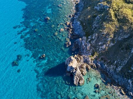 Aerial view of Tropea beach, crystal clear water and rocks that appear on the beach. Rock Pizzuta. Calabria, Italyの写真素材
