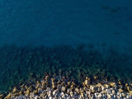 Aerial view of rocks on the sea. Overview of seabed seen from above, transparent water.の写真素材