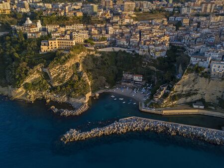 Aerial view of Pizzo Calabro, Calabria, tourism Italy. Panoramic view of the small town of Pizzo Calabro by the sea. Houses on the rock. On the cliff stands the Convento S. Francesco Di Paola. Seafront at sunsetの写真素材