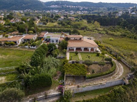 Aerial view of the Calabrian coast, villas and resorts on the cliff. Transparent sea and wild coast. Locality of Riaci near Tropea, Calabria. Italyの写真素材