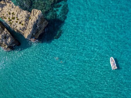 Aerial view of the Riaci rocks, Riaci beach near Tropea, Calabria. Italy. Beaches and crystal clear sea. A dinghy moored and swimmers who swim and snorkelの写真素材