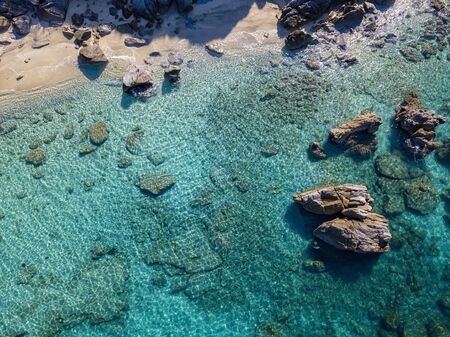 Aerial view of Tropea beach, crystal clear water and rocks that appear on the beach. Calabria, Italy. Swimmers, bathers floating on the water. Tyrrhenian Sea. Coastline of Calabriaの写真素材