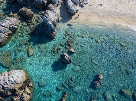 Aerial view of Tropea beach, crystal clear water and rocks that appear on the beach. Calabria, Italy. Swimmers, bathers floating on the water. Tyrrhenian Sea. Coastline of Calabriaの写真素材