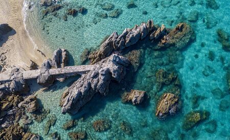 Aerial view of Tropea beach, crystal clear water and rocks that appear on the beach. Calabria, Italy. Swimmers, bathers floating on the water. Tyrrhenian Sea. Coastline of Calabriaの写真素材