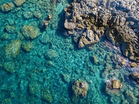 Aerial view of Tropea beach, crystal clear water and rocks that appear on the beach. Calabria, Italy. Swimmers, bathers floating on the water. Tyrrhenian Sea. Coastline of Calabriaの写真素材
