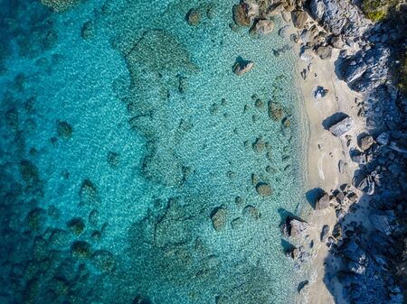 Aerial view of Tropea beach, crystal clear water and rocks that appear on the beach. Calabria, Italy. Swimmers, bathers floating on the water. Tyrrhenian Sea. Coastline of Calabriaの写真素材