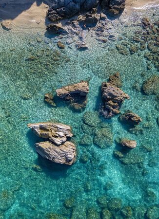 Aerial view of Tropea beach, crystal clear water and rocks that appear on the beach. Calabria, Italy. Swimmers, bathers floating on the water. Tyrrhenian Sea. Coastline of Calabriaの写真素材