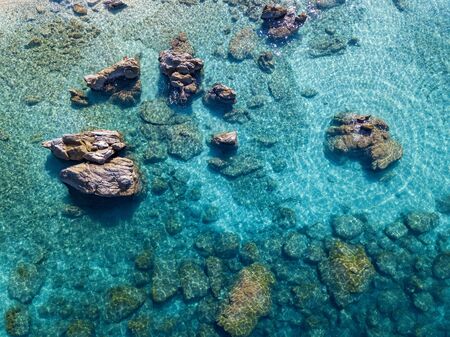 Aerial view of Tropea beach, crystal clear water and rocks that appear on the beach. Calabria, Italy. Swimmers, bathers floating on the water. Tyrrhenian Sea. Coastline of Calabriaの写真素材