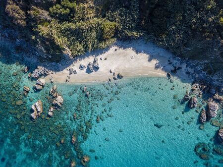 Aerial view of Tropea beach, crystal clear water and rocks that appear on the beach. Calabria, Italy. Swimmers, bathers floating on the water. Tyrrhenian Sea. Coastline of Calabriaの写真素材