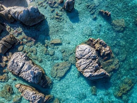 Aerial view of Tropea beach, crystal clear water and rocks that appear on the beach. Calabria, Italy. Swimmers, bathers floating on the water. Tyrrhenian Sea. Coastline of Calabriaの写真素材