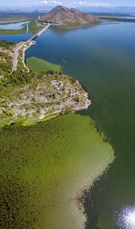 Aerial view of Lake Skadar or Lake Shkodra, Montenegro. Surrounded by the national park created by nature and wildlife, hills and mountains. It is the largest lake on the Balkan peninsula. Balkan largest lakeの写真素材