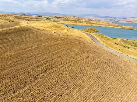 Aerial view of rural areas south of Lokman in the province of Adiyaman, Turkey. Inlets on the Euphrates river formed by the Ataturk dam. Desert landsの写真素材