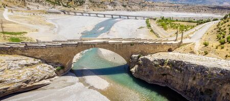 Aerial view of the Severan Bridge, Cendere Koprusu is a late Roman bridge, close to Nemrut Dagi and Adiyaman, Turkey. Flanked roadway by ancient columns of Roman Emperor Lucius Septimius Severusの写真素材