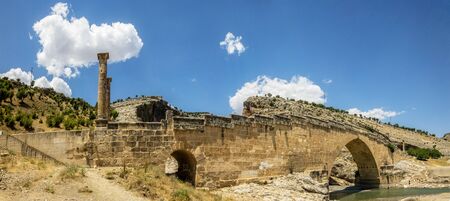 Panoramic view of Severan Bridge, Cendere Koprusu is a late Roman bridge, close to Nemrut Dagi and Adiyaman, Turkey. Flanked roadway by ancient columns of Roman Emperor Lucius Septimius Severusの写真素材