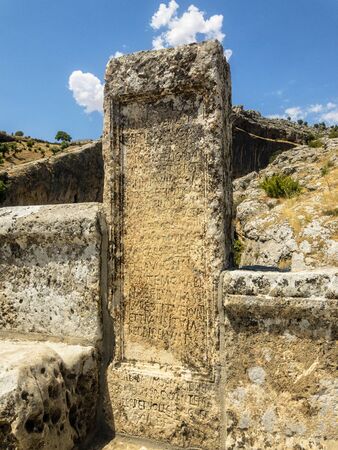 Inscription on Severan Bridge, Cendere Koprusu is a late Roman bridge, close to Nemrut Dagi and Adiyaman, Turkey. Flanked roadway by ancient columns of Roman Emperor Lucius Septimius Severusの写真素材