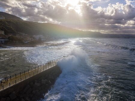 Aerial view of a pier with rocks and rocks on the sea. Pizzo Calabro pier, panoramic view from above. Broken pier, force of the sea. Power of Waves. Natural disasters, climate change. Calabria, Italyの写真素材