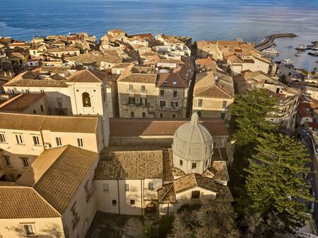 Aerial view of the cathedral, Cathedral of Maria Santissima of Romania. Roofs and houses of the city of Tropea, Calabria. Italy.の写真素材