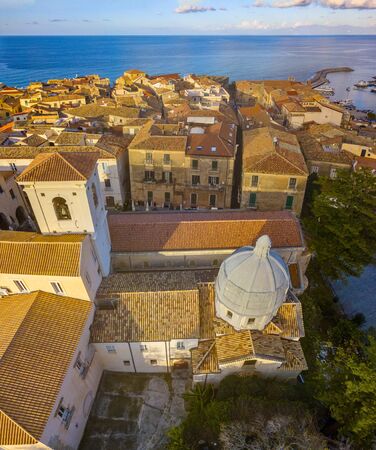 Aerial view of the cathedral, Cathedral of Maria Santissima of Romania. Roofs and houses of the city of Tropea, Calabria. Italy.の写真素材