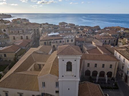 Aerial view of the cathedral, Cathedral of Maria Santissima of Romania. Roofs and houses of the city of Tropea, Calabria. Italy.の写真素材