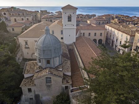 Aerial view of the cathedral, Cathedral of Maria Santissima of Romania. Roofs and houses of the city of Tropea, Calabria. Italy.の写真素材