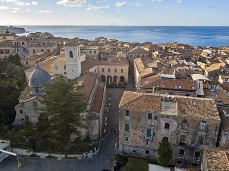 Aerial view of the cathedral, Cathedral of Maria Santissima of Romania. Roofs and houses of the city of Tropea, Calabria. Italy.の写真素材
