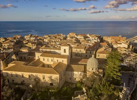 Aerial view of the cathedral, Cathedral of Maria Santissima of Romania. Roofs and houses of the city of Tropea, Calabria. Italy.の写真素材