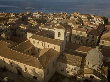 Aerial view of the cathedral, Cathedral of Maria Santissima of Romania. Roofs and houses of the city of Tropea, Calabria. Italy.の写真素材
