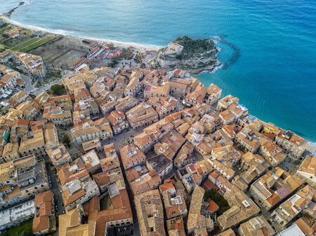 Aerial view of Tropea, house on the rock and Sanctuary of Santa Maria dell'Isola, Calabria. Italy. Tourist destinations of the most famous in Southern Italy, seaside resort located on a cliff in the gulf of Sant'Eufemia. Rooftopsの写真素材