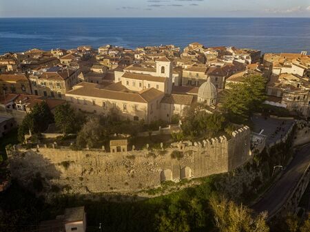 Aerial view of the cathedral, Cathedral of Maria Santissima of Romania. Roofs and houses of the city of Tropea, Calabria. Italy.の写真素材