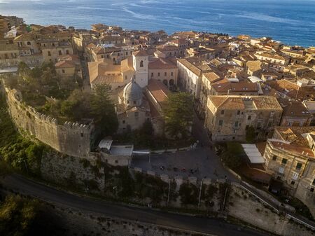 Aerial view of the cathedral, Cathedral of Maria Santissima of Romania. Roofs and houses of the city of Tropea, Calabria. Italy.の写真素材
