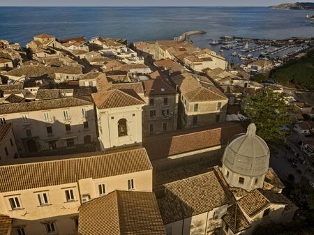 Aerial view of the cathedral, Cathedral of Maria Santissima of Romania. Roofs and houses of the city of Tropea, Calabria. Italy.の写真素材