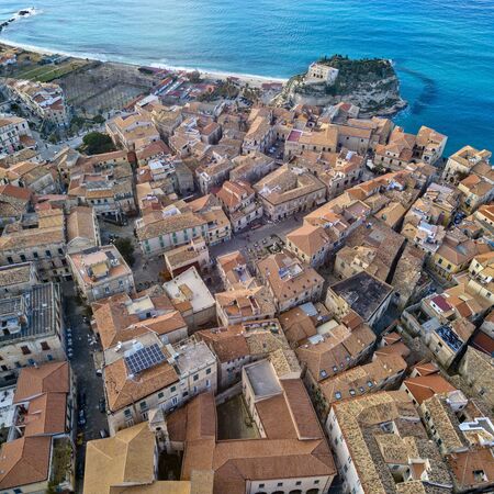 Aerial view of Tropea, house on the rock and Sanctuary of Santa Maria dell'Isola, Calabria. Italy. Tourist destinations of the most famous in Southern Italy, seaside resort located on a cliff in the gulf of Sant'Eufemia. Rooftopsの写真素材