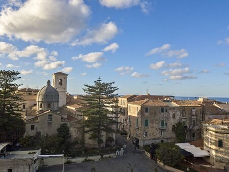Aerial view of the cathedral, Cathedral of Maria Santissima of Romania. Roofs and houses of the city of Tropea, Calabria. Italy.の写真素材
