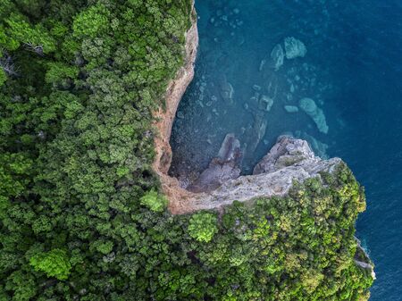 Aerial view of a steep cliff, unspoiled nature of the Montenegro coast. Sea caves and inlets alternate on the Mediterranean coast.の写真素材
